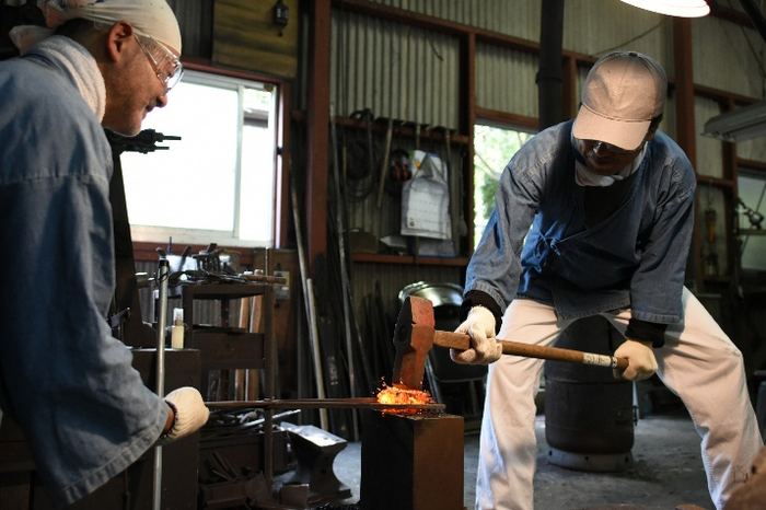 Blacksmith forging a blade
