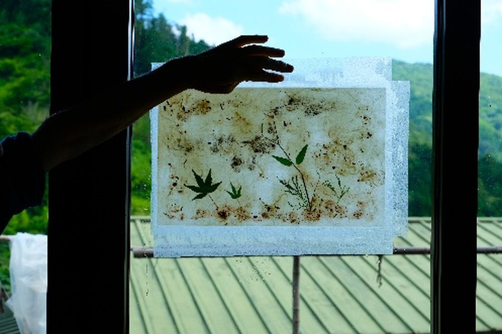 Finished washi art piece held up to the light